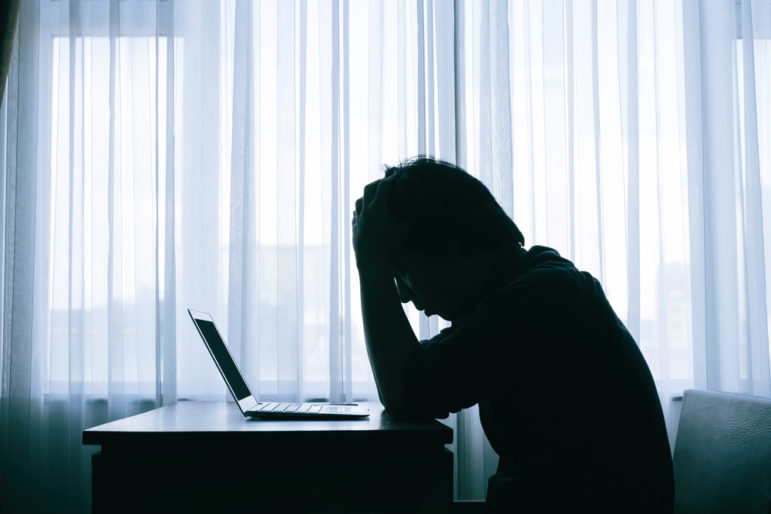 A,Stressed,Person,Feeling,Unhappy,Sitting,With,His,Laptop,In