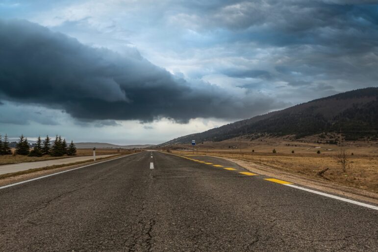 Dark clouds over a country road.
