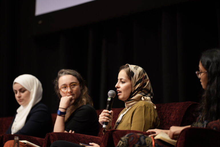 Al Jazeera's Laila Al-Arian, with microphone in hand, speaks during the session on Gaza at the GIJC in Malaysia. Image: Alyaa Alhadjri for GIJN
