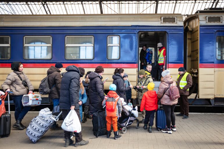 Ukrainian refugees at Lviv railway station in 2022, waiting for a train to leave Ukraine. Image: Shutterstock