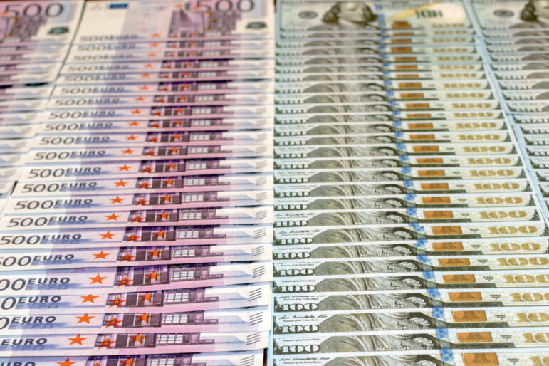 500,Euros,And,100,Dollars,Bills,Laid,Out,On,A