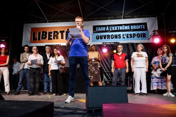 Mathieu Molard speaking at a Paris rally organized by a coalition of independent media and civil society groups ahead of France's 2024 snap legislative elections.