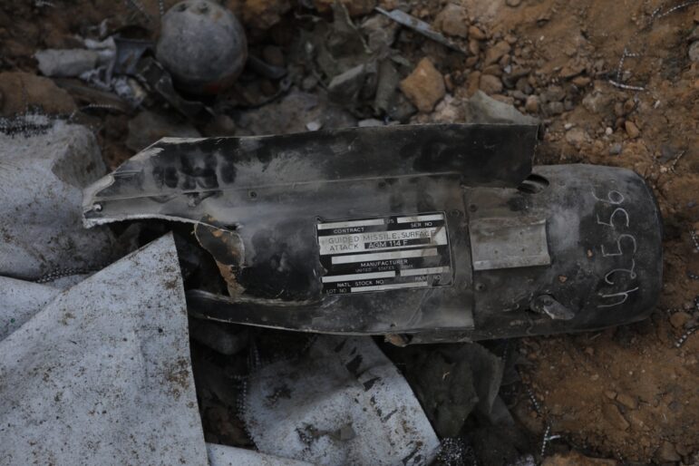 Hellfire missile fragment showing US marking plate and serial number at crater site in Gaza. 